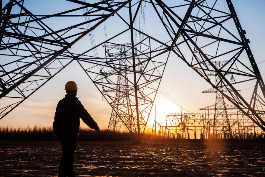 electricity workers and pylon silhouette